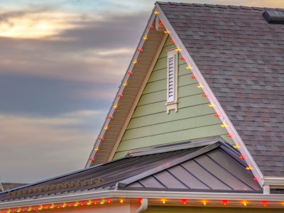 Roof,With,Christmas,Lights,Against,Cloudy,Sky